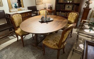 Staged shot of an antique Table a Vigneron with 4 Louis XV style chairs